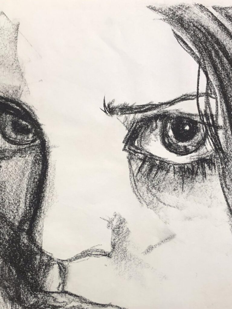 drawing of a face, showing eyes and nose. Worked with charcoal.