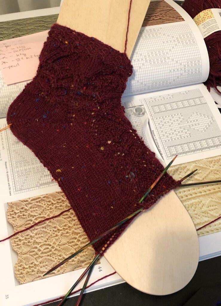 knitted almost finished sock in darf read with japanes lace